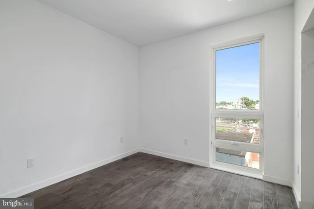 spare room with dark wood-type flooring