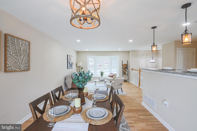 dining space featuring a chandelier and light hardwood / wood-style floors