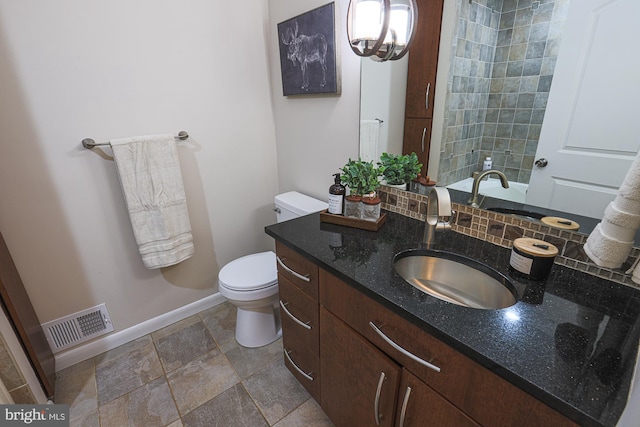 bathroom with decorative backsplash, vanity, and toilet