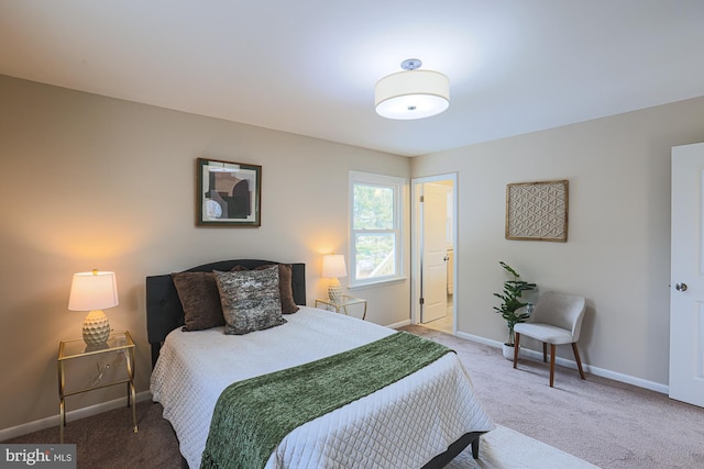 carpeted bedroom featuring connected bathroom