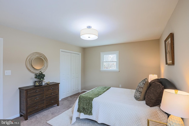 bedroom featuring light carpet and a closet