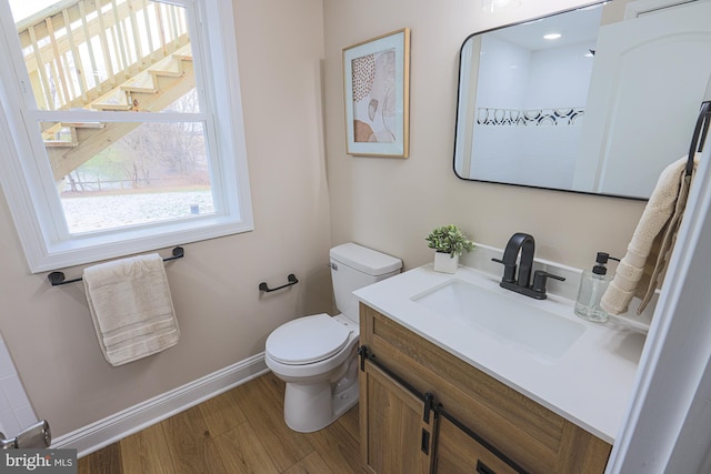 bathroom featuring vanity, hardwood / wood-style flooring, and toilet