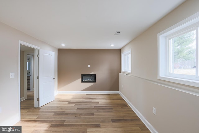 spare room with light hardwood / wood-style flooring