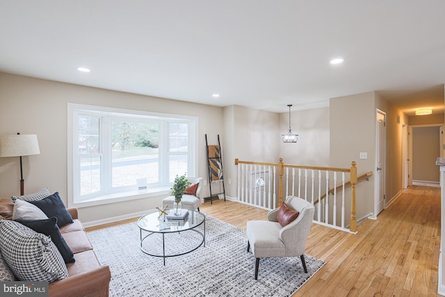 living room featuring a chandelier and light hardwood / wood-style flooring