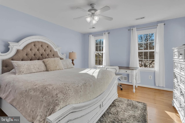 bedroom featuring multiple windows, light hardwood / wood-style flooring, and ceiling fan