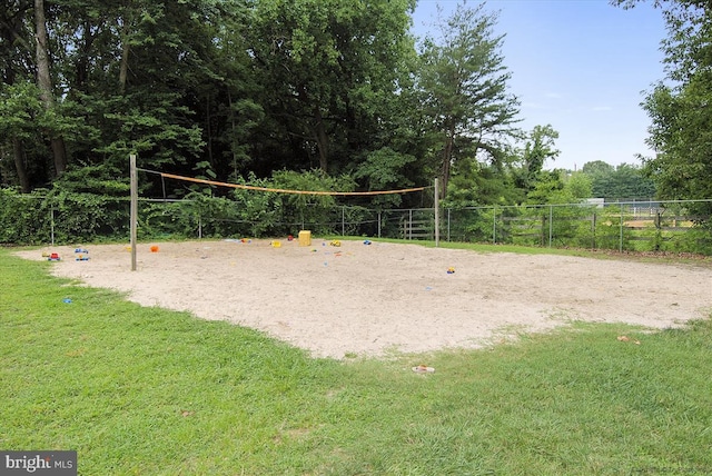 view of property's community featuring a lawn and volleyball court