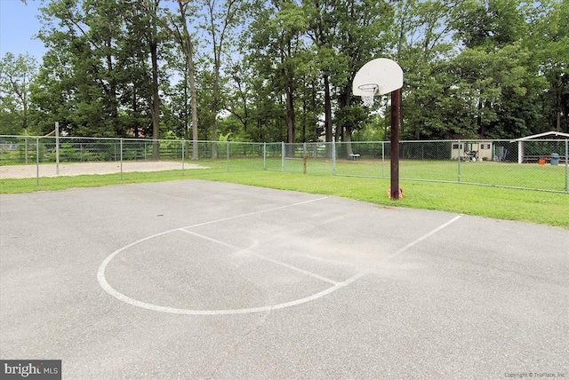 view of basketball court featuring a yard