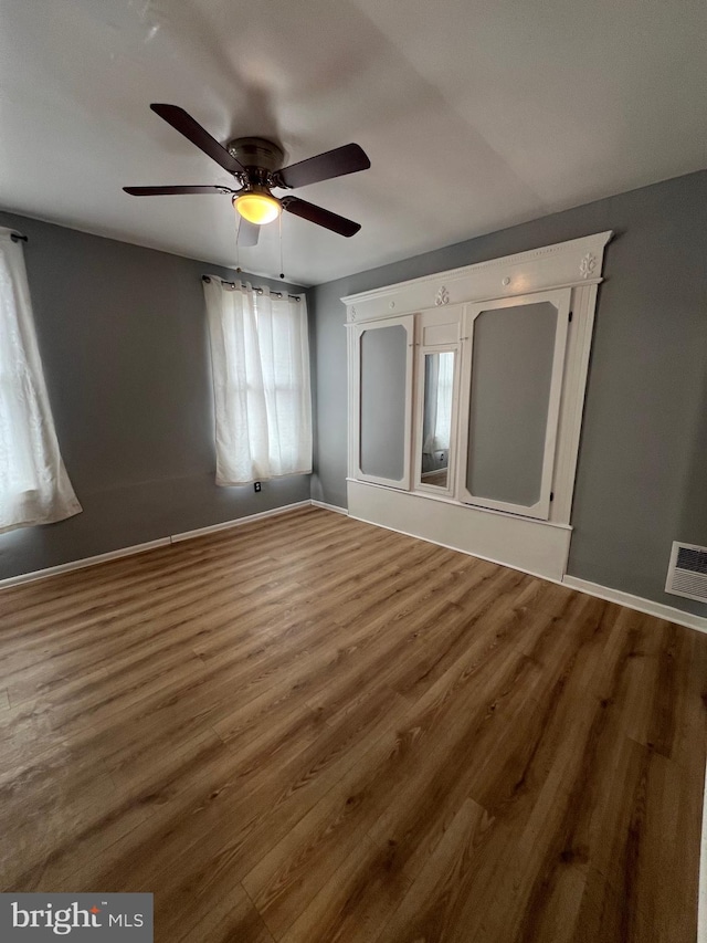 unfurnished bedroom with wood-type flooring and ceiling fan