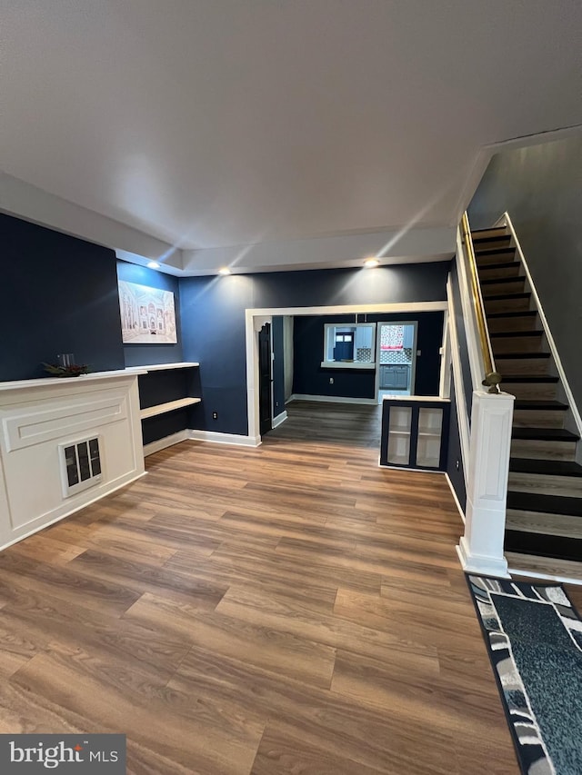 unfurnished living room featuring wood-type flooring