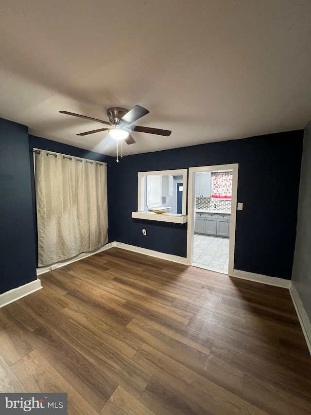 unfurnished room featuring hardwood / wood-style floors and ceiling fan