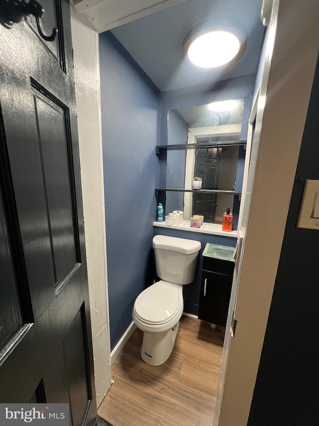 bathroom with hardwood / wood-style floors and toilet