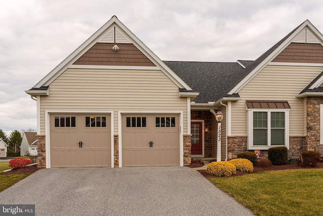 craftsman-style home featuring a front yard and a garage