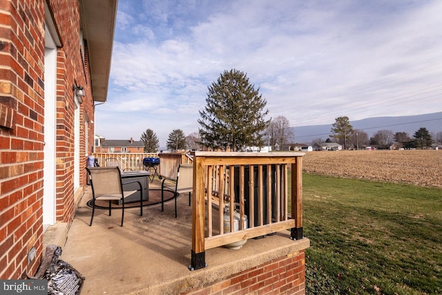 wooden deck with a lawn