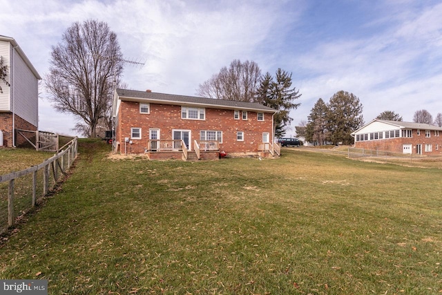 rear view of house with a yard