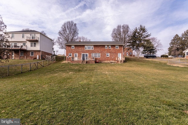 back of house featuring a lawn