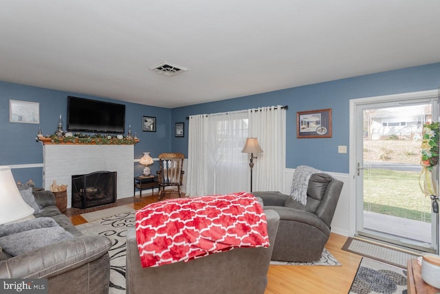 living room with hardwood / wood-style floors and a fireplace