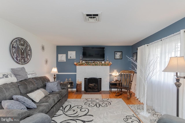 living room with a fireplace and light hardwood / wood-style flooring