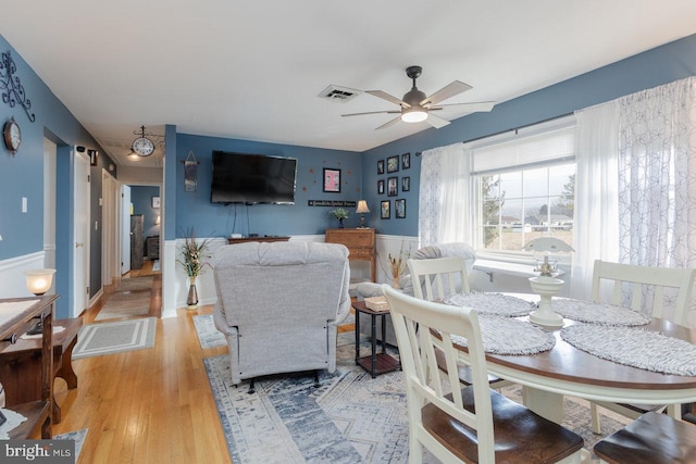 living room featuring light wood-type flooring and ceiling fan