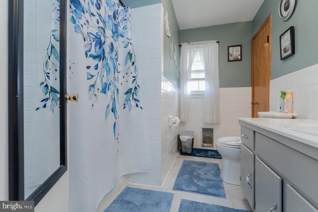 bathroom with tile patterned floors, vanity, tile walls, and a shower with shower curtain