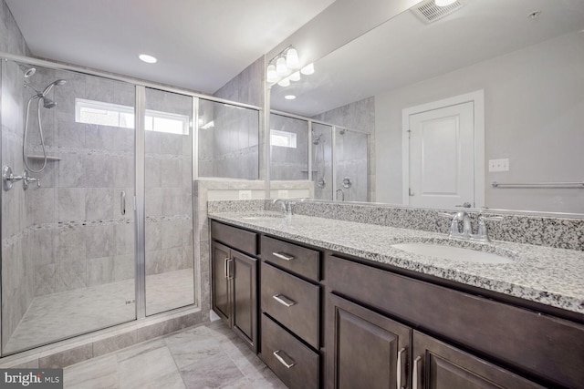 bathroom with vanity and a shower with shower door