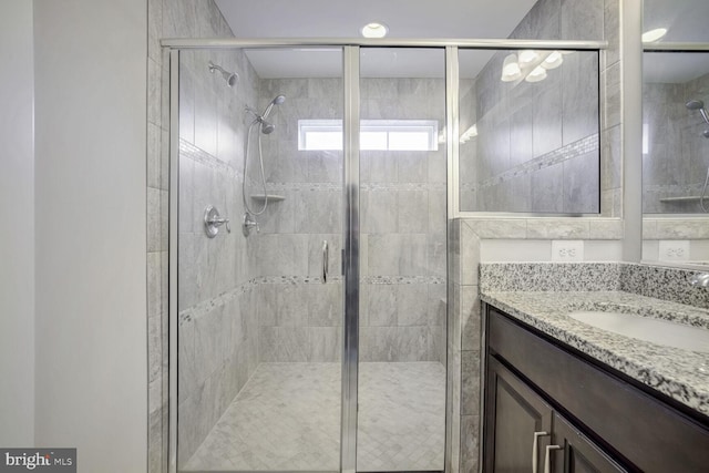 bathroom with vanity and an enclosed shower