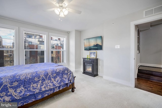 carpeted bedroom featuring ceiling fan