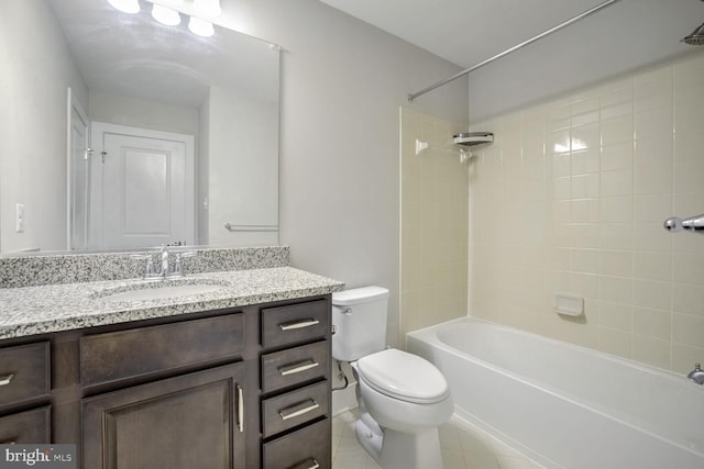 full bathroom featuring tiled shower / bath combo, toilet, and vanity