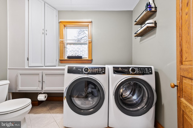 laundry area featuring separate washer and dryer and light tile patterned floors