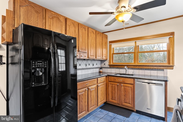 kitchen with dishwasher, sink, tasteful backsplash, black refrigerator with ice dispenser, and dark tile patterned flooring