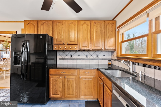 kitchen with sink, tasteful backsplash, black refrigerator with ice dispenser, stainless steel dishwasher, and dark stone counters