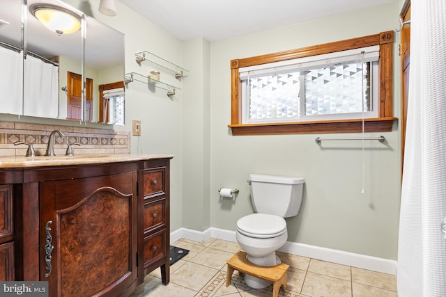 bathroom with tasteful backsplash, tile patterned floors, and a wealth of natural light