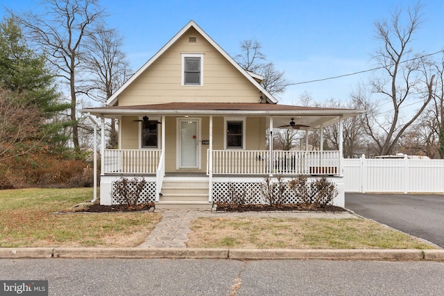 farmhouse with a front yard and a porch