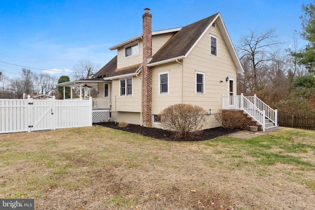 rear view of house with a yard