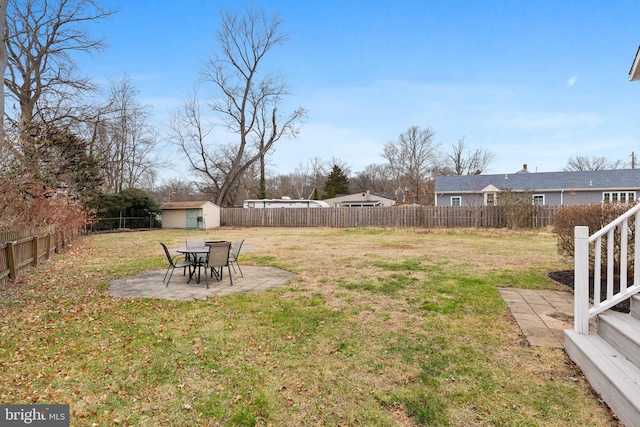 view of yard featuring a storage unit and a patio area