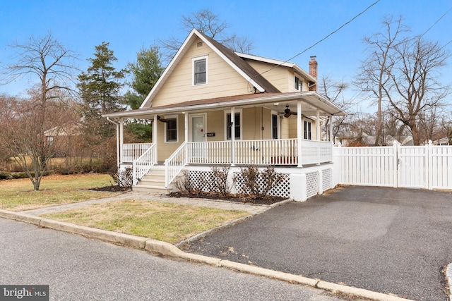 farmhouse with covered porch and a front yard