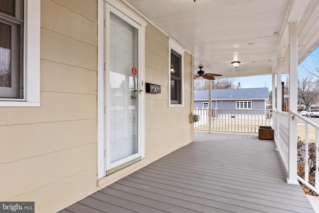 wooden terrace featuring ceiling fan and a porch