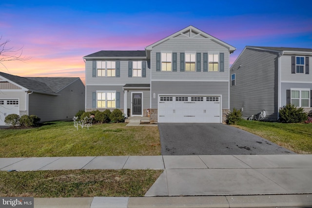 view of front of home featuring a garage and a lawn