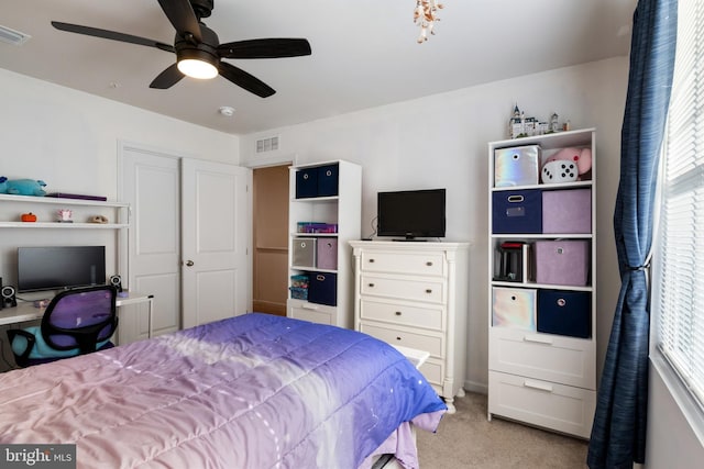 bedroom featuring light carpet, a closet, and ceiling fan