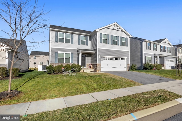 view of front facade featuring a front yard, central AC, and a garage