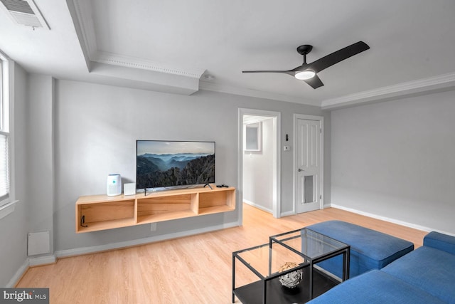 living room with hardwood / wood-style floors, ceiling fan, and ornamental molding