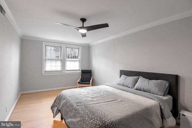 bedroom featuring light wood-type flooring, ceiling fan, and ornamental molding