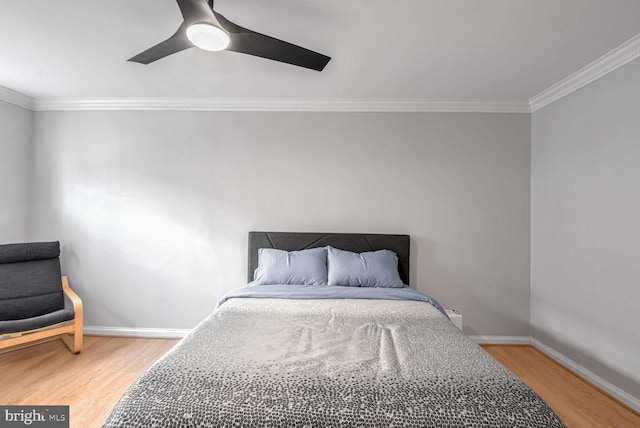 bedroom with ceiling fan, crown molding, and wood-type flooring