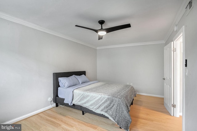 bedroom with ceiling fan, light wood-type flooring, and ornamental molding