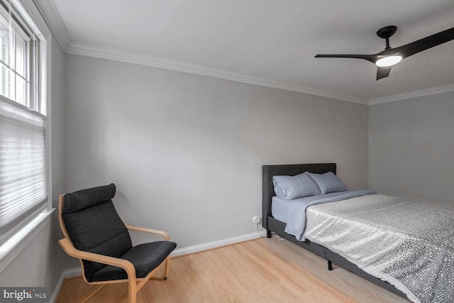 bedroom featuring ceiling fan, light hardwood / wood-style flooring, and crown molding