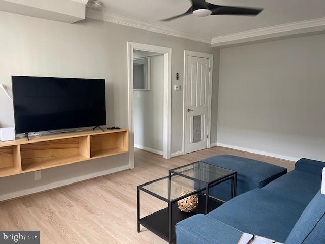 living room with ceiling fan, ornamental molding, and hardwood / wood-style flooring