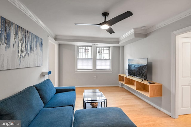 living room with ceiling fan, light wood-type flooring, and ornamental molding