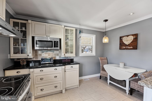 kitchen with decorative backsplash, crown molding, decorative light fixtures, and cream cabinetry