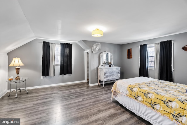 bedroom with vaulted ceiling and hardwood / wood-style flooring