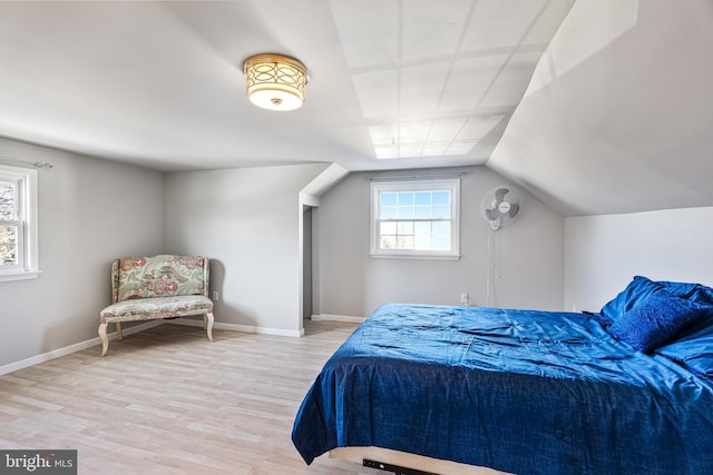 bedroom featuring lofted ceiling and light hardwood / wood-style flooring