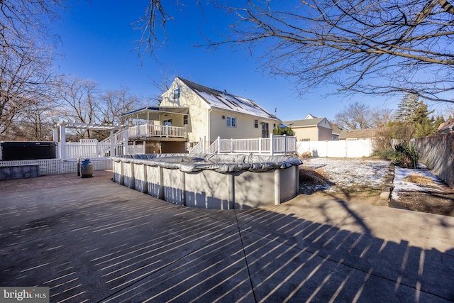 wooden deck featuring a covered pool